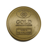 Grinder en métal doré 4 parties avec inscription GOLD et logo The World Over en relief, idéal pour accessoires CBD à Metz
